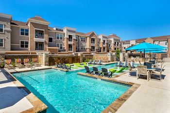 Resort-style pool with tanning ledge and sundeck