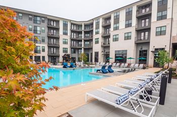 Resort-style saltwater swimming pool with tanning ledges and sundeck