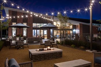 Poolside outdoor lounge with firepit and grills