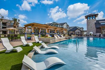 Resort-style swimming pool with sunning ledge and beach entry