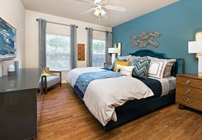 Cary apartment for rent - a bedroom with a bed and a ceiling fan