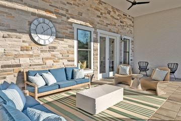 Gallatin apartment for rent - A living room with a blue couch and a stone wall.