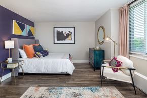 Richmond apartment for rent - A bedroom with a white bed and a blue cabinet.