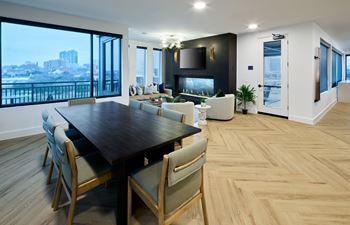 South building: sky lounge with remote work lounge, event kitchen, billiards table, and outdoor lounge with seating and fireplace