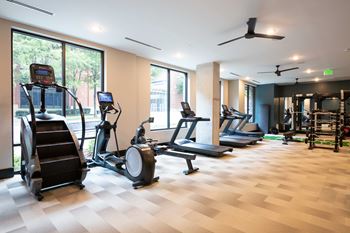 Cardio and strength training fitness center featuring echelon smart connect exercise bikes, hiit hub with trx suspension trainer, free weights