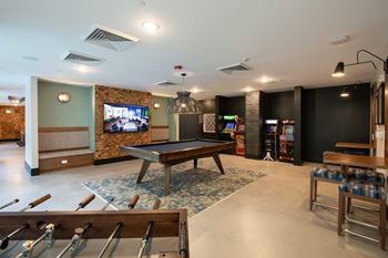 Gaming lounge with billiards, foosball, and vintage arcade games