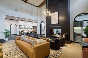 Grand Prairie apartment for rent - A living room with a brown sofa and a chandelier.