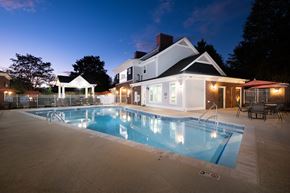 Davidson townhouse for rent - A large house with a pool in the backyard.