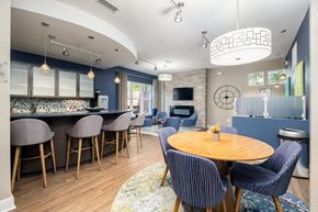 Davidson townhouse for rent - A modern kitchen with a bar area and a dining table set up.