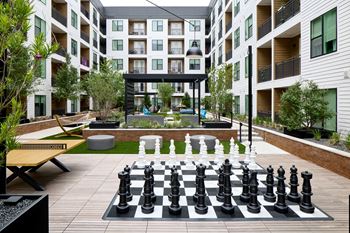 South building courtyards with grilling and picnic areas, yard games, hammock park, lounge areas, and fire pit with cozy seating