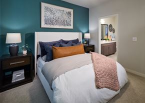 Euless apartment for rent - A bedroom with a white bed and a pink blanket.