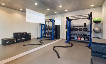 North building: 24-hour cardio & strength training fitness center with peloton bike, peloton row, pilates reformer, trx training equipment, yoga and stretching area, with outdoor fitness center