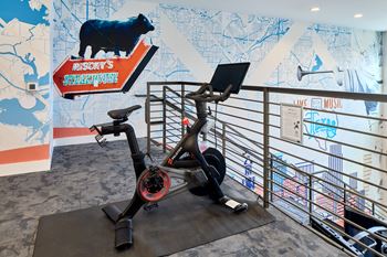 North building: 24-hour cardio & strength training fitness center with peloton bike, peloton row, pilates reformer, trx training equipment, yoga and stretching area, with outdoor fitness center