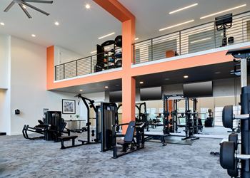 North building: 24-hour cardio & strength training fitness center with peloton bike, peloton row, pilates reformer, trx training equipment, yoga and stretching area, with outdoor fitness center