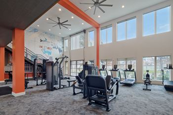 North building: 24-hour cardio & strength training fitness center with peloton bike, peloton row, pilates reformer, trx training equipment, yoga and stretching area, with outdoor fitness center