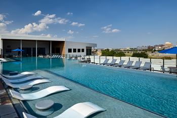 North building: rooftop infinity edge pool with outdoor lounge, cabanas and jumbotron