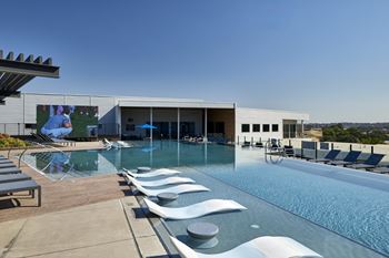 North building: rooftop infinity edge pool with outdoor lounge, cabanas and jumbotron
