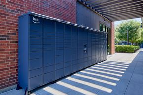 Fort Worth apartment for rent - A large dark blue Amazon storage unit is on a sidewalk.