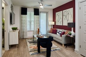 Fort Worth apartment for rent - A living room with a black chair and a white sofa.