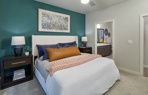 Euless apartment for rent - A bedroom with a bed, nightstands, and a painting on the wall.