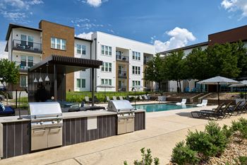 Poolside grilling area with shuffleboard court and cornhole