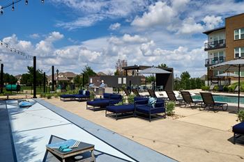 Poolside grilling area with shuffleboard court and cornhole