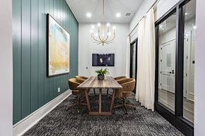 Cumming apartment for rent - a dining room with a wooden table and chairs and a chandelier