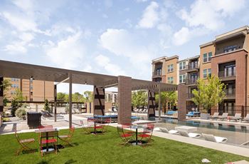 Poolside game area with cornhole boards