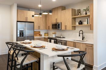 European-style natural wood look cabinetry with black hardware (a)
