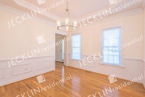 Glen Allen house for rent - an empty dining room with a chandelier and hardwood floors
