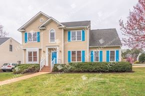 Henrico house for rent - A house with blue shutters and a blue door.