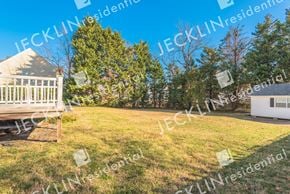 Glen Allen house for rent - a large yard with a deck and trees in the background