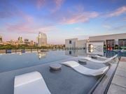 Fort Worth apartment for rent - a rooftop pool with lounge chairs and a view of the city