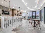 Fort Worth apartment for rent - A modern kitchen with a bar area and a dining table.