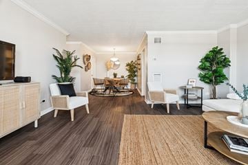 New Orleans apartment for rent - A living room with a brown rug and white furniture.
