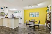 Tampa apartment for rent - Open kitchen and dining area with yellow accent wall at The Arbor Walk Apartments, Tampa, FL 33617