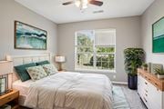 Greensboro apartment for rent - A bedroom with a bed, a ceiling fan, and a painting on the wall. at Bridford Lake Apartments, North Carolina, 27407