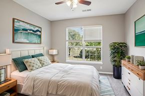 Greensboro apartment for rent - A bedroom with a bed, a ceiling fan, and a painting on the wall. at Bridford Lake Apartments, North Carolina, 27407