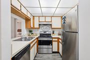 Melbourne apartment for rent - A kitchen with a stainless steel refrigerator and a stove top oven. at Lakeside Glen Apartments, Florida, 32904