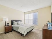 Raleigh apartment for rent - A bedroom with a bed, nightstand, and window. at Cedar Springs Apartments, Raleigh, NC, 27609