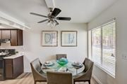 Mesa apartment for rent - a dining area with a glass table and chairs and a ceiling fan at Glen at Mesa Apartments, AZ 85201