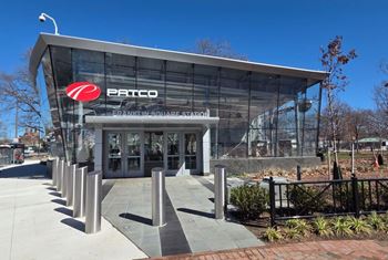 The patco building has a glass facade and a red logo