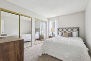 Melbourne apartment for rent - A bedroom with a large bed and a wooden dresser. at Lakeside Glen Apartments, Melbourne, FL