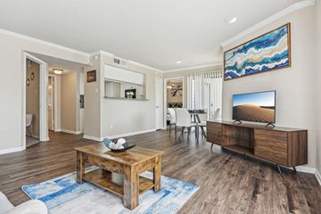 Dallas apartment for rent - a living room with a table and a television