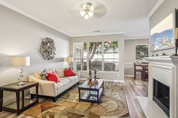 Greensboro apartment for rent - A living room with a white couch and a fireplace.
