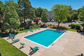 Colorado Springs apartment for rent - A swimming pool surrounded by green trees and lawn chairs.at The Montecito, Colorado, 80916