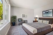 Colorado Springs apartment for rent - A bedroom with a large bed and a painting on the wall. at Windmill Apartments, Colorado Springs, Colorado