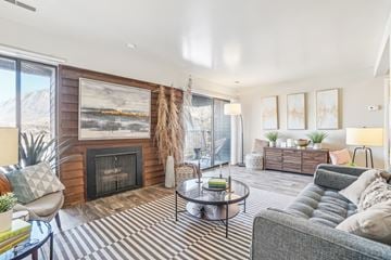 Ogden apartment for rent - A living room with a fireplace and a painting on the wall.