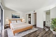 Mesa apartment for rent - A bedroom with a large bed and a painting on the wall at Del Coronado Apartment , Mesa, 85202