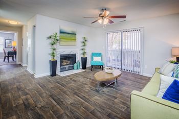 A living room with a fireplace and a ceiling fan